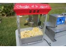Red and white popcorn machine rental in Houston with ornate scroll details, ideal for League City parties.