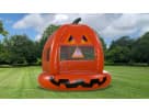 Bright orange pumpkin bounce house rental in Dallas with carved jack-o'-lantern face, ideal for fall festivals and Fort Worth