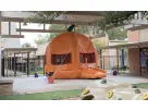 Pumpkin bounce house rental in Dallas with bright orange and green colors, ideal for Irving fall parties.