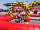Red obstacle race track game rental with bold yellow checkered details, ideal for Plano celebrations.