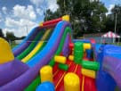 Retro Radical obstacle course rental in Austin with rock wall climb and slides, ideal for Round Rock backyard parties.