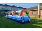 Rainbow slip n slide water rental set up in a Dallas backyard, perfect for kids cooling off on hot summer days in Grand Prairie.