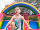 Rainbow kids water slide rental in Houston with wet or dry functionality, ideal for Pasadena birthday parties.