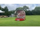 Inflatable Christmas snow globe rental with festive lights available in Dallas, perfect for holiday parties in Mesquite