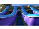 Blue and purple dual-lane water slide rental in Austin, ideal for backyard parties—18ft wet slide with central staircase, popular