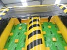 Yellow and black striped obstacle course rental in Austin with foam climbing sections, perfect for Kyle parties.
