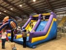 Dual-slide inflatable rockwall rental in Austin with climbing wall and slides, ideal for Buda birthday parties and events.