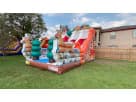 Christmas Santa Claus 20ft dual lane dry slide rental in Austin, ideal for Cedar Park holiday parties with festive reindeer