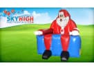 Perfect for holiday parties in Dallas, this giant inflatable Santa chair rental features a red and blue design ideal for guest