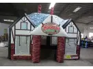 Perfect for Christmas events in Dallas, this Santa's Workshop inflatable rental features a charming red brick and timber design