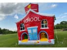 School House & Bus obstacle course rental in Houston—red and blue inflatable with yellow entrances, ideal for Sugar Land birthday