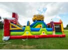 Colorful school bus obstacle course rental in Houston featuring slides and climbing elements, ideal for Cypress birthday parties