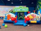 Sesame Street toddler bounce house rental in Austin with Elmo characters and slide, ideal for Round Rock birthday parties.