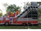 Perfect for Austin birthday parties, this fire truck bounce house rental features a dry slide ideal for all ages.