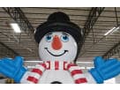 Giant inflatable snowman jump house rental for Kingwood parties features a cheerful face with top hat and striped scarf.