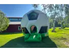 Soccer bounce house rental in Austin with large inflatable ball design, ideal for Buda kids' parties.