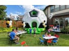 Soccer bounce house rental in Dallas with large inflatable ball design, perfect for kids of all ages at Frisco birthday parties.