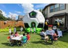 Large soccer-themed bounce house rental in Dallas with black and white inflatable ball design, perfect for kids of all ages