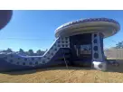 UFO spaceship bounce house rental in Austin with slide, holds up to 6 kids—perfect for Pflugerville backyard parties.