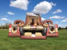 Military-themed obstacle course rental in Dallas with dual slides and climbing wall, ideal for large events in Grand Prairie.
