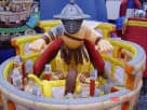 Colossal gladiator obstacle course rental in Dallas with crawl-through pop-out challenges, ideal for large Lewisville events.