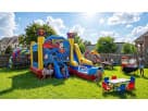 Superman 6-in-1 combo bounce house with wet or dry slide rental setup in Houston backyard, popular for birthday parties