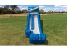 Blue and white Tidal Wave water slide rental in Austin, perfect for ages 3 and up with wet or dry play, set up in a grassy park.