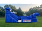 Bright blue tidal wave water slide rental for Austin featuring dual lanes and wave graphics, perfect for Buda celebrations.