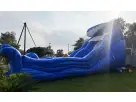 Blue Tidal Wave water slide rental in Austin with wet or dry functionality, set up in residential backyard ideal for Georgetown