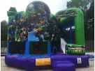TMNT themed slide bounce house rental in Dallas boasts green, blue, and purple design ideal for Irving backyard parties.