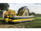 Yellow and black obstacle course rental in Dallas with dual slides and crawl tubes, ideal for kids' parties in Fort Worth.