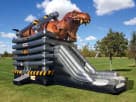 Ultimate T-Rex bounce house rental with dual slides available in Houston, ideal for Cypress birthday parties.