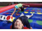 Inflatable Twister game rental in Houston with colorful red, blue, and yellow panels, ideal for League City birthday parties