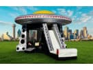 UFO bounce house rental in Dallas boasts a striking yellow saucer and integrated slide, ideal for Lewisville parties.