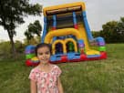Colorful dual-slide bounce house rental in Austin with rock wall climb feature, ideal for Pflugerville birthday parties and all