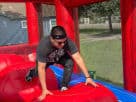 Wipe Out Leaps n Bounds bounce house rental in Austin showcases durable red and blue design, ideal for Buda parties.