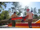 Red and black interactive bounce house rental in Houston with dual jousting poles, ideal for kids ages 5 and up at Spring
