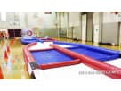 Red and blue inflatable obstacle course rental in Houston with padded walls, ideal for interactive parties and events with kids