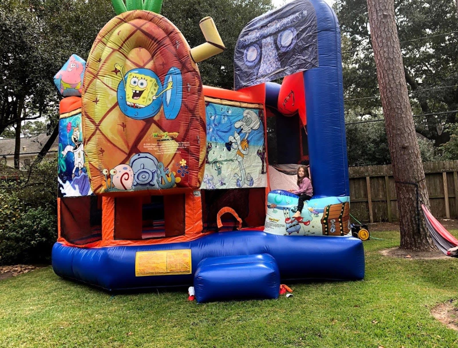 Birthday girl sitting on Spongebob Squarepants bounce house repost Google Review