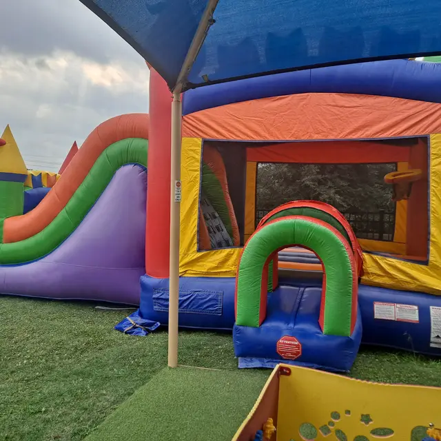 Modern Rainbow Bounce House Combo set up in Missouri City, TX